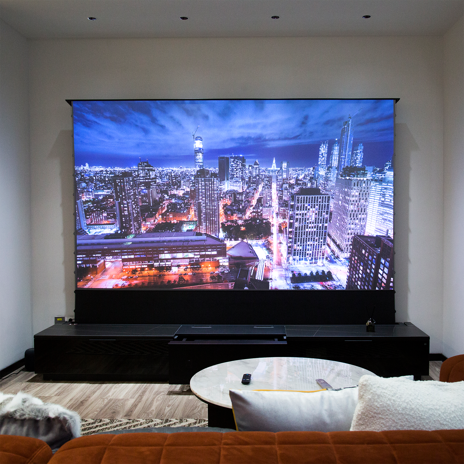 The living room features the LTV-3500 Pro 4K laser projector, motorized screen, and smart cabinetry for a cinematic experience.