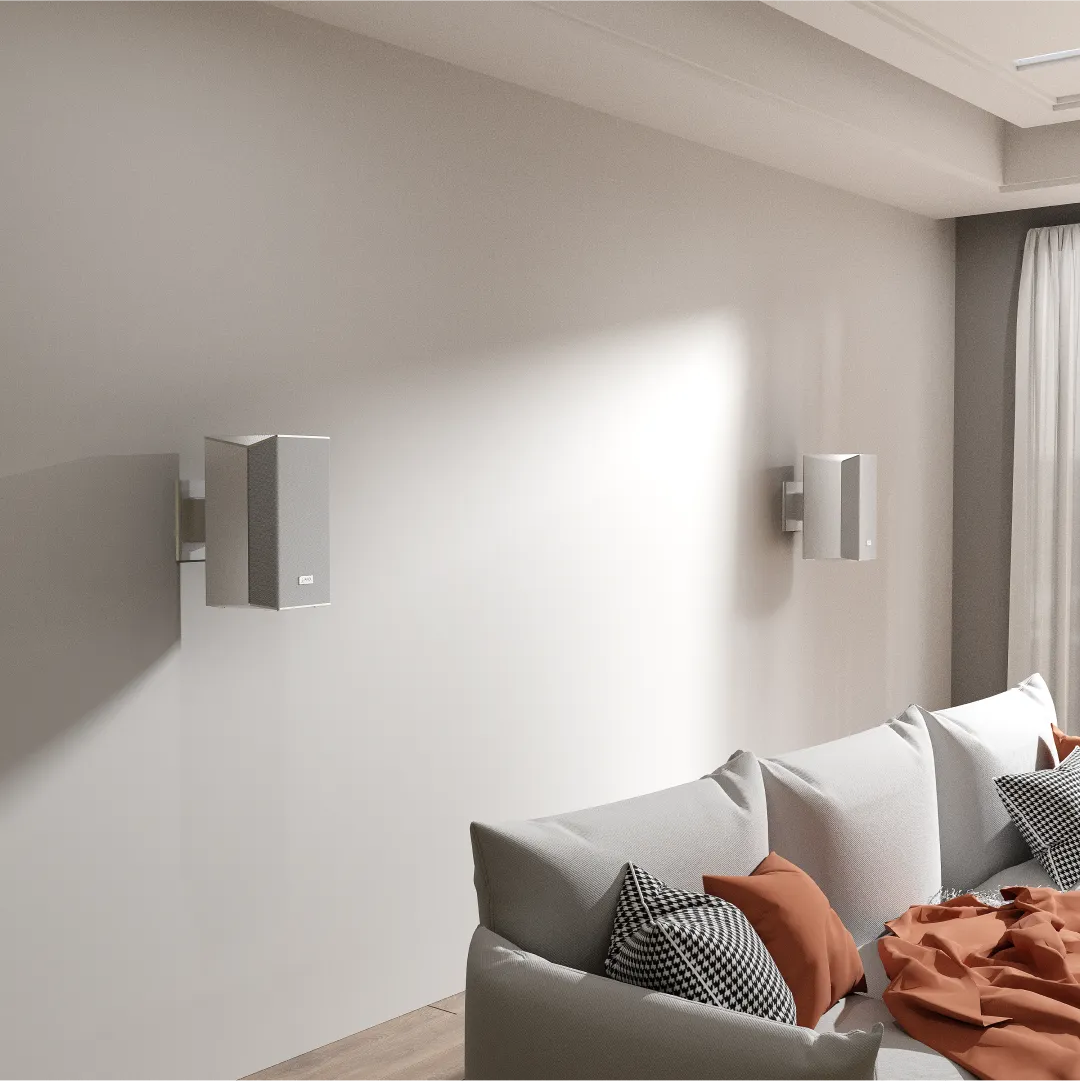 AWOL Vision's wireless surround sound speakers mounted on a living room wall.